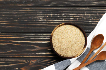 amaranth in a bowl on a wooden background with place for text
