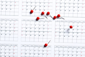 Many close up of pin on calendar planning for business meeting or travel planning concept