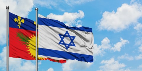 Guadeloupe and Israel flag waving in the wind against white cloudy blue sky together. Diplomacy concept, international relations.