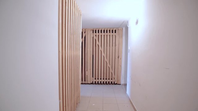 Walking into the condo basement 4K. Dolly slide through the hallway of personal basement storage space.