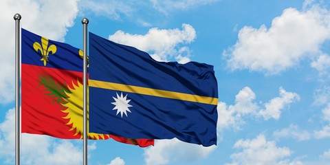 Guadeloupe and Nauru flag waving in the wind against white cloudy blue sky together. Diplomacy concept, international relations.