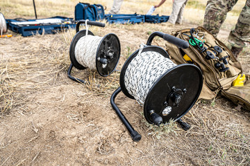Explosive Ordinance Disposal teams set up rope to rig a bomb extraction