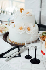 Luxury wedding cake. Holiday cakes for gourmets. Wedding cake. A Wedding cakes stands on the decorated table. The served table at restaurant for a banquet. Restaurant set.