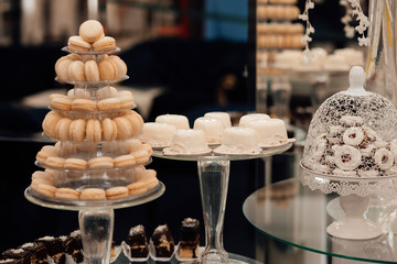 Candy bar for the wedding.Wedding decoration with pastel colored cupcakes, meringues, muffins and macarons. Elegant and luxurious event arrangement.  Luxury life.
