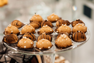 Luxury wedding catering, table with modern desserts, cupcakes. Delicious candy bar at expensive wedding reception. Holiday celebration