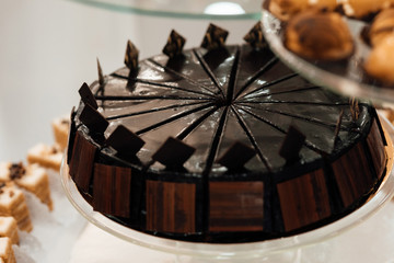 Sweet sliced cakes at white plate. Wedding reception party. Delicious  cake on the buffet table.  Luxury life.  Dessert table at wedding reception