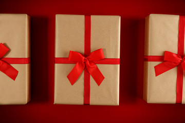 Red flat lay background of christmas time. Free empty space for your product. Xmas gifts decoration and copy space. Cold winter december day and Santa Claus boxes. Top view, aerial photo.