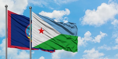 Guam and Djibouti flag waving in the wind against white cloudy blue sky together. Diplomacy concept, international relations.