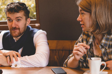 A guy and a girl in a cafe tell a fascinating story.