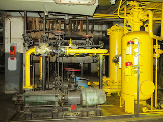 Naklejka premium Industrial big water pumps with electric motors, pipes, tubes, equipment and steam turbine at power plant