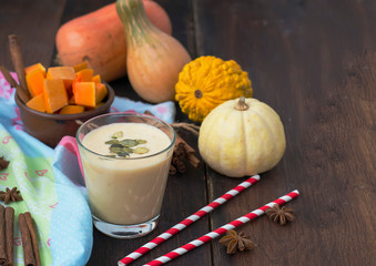 smoothies with pumpkins in a glass, on a concrete background