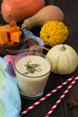 smoothies with pumpkins in a glass, on a concrete background
