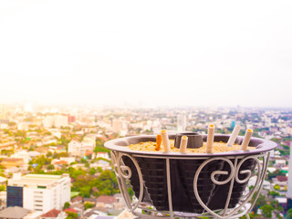 The rest of cigarettes in the ashtray. A cigarette is not good for health and environment. It is not allow to smoking in the public area in Thailand. Cigarette smoke is air pollution.