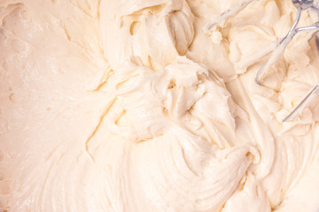 Culinary background - kneading dough for baking close-up, beige tint