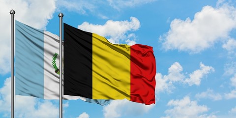 Guatemala and Belgium flag waving in the wind against white cloudy blue sky together. Diplomacy concept, international relations.