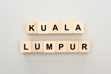 top view of wooden blocks with Kuala Lumpur lettering on grey background