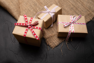 gift box with red ribbon and bow on wooden background