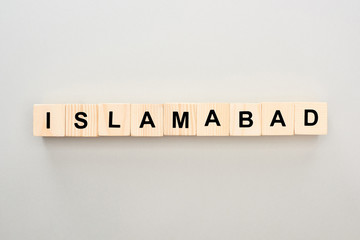 top view of wooden blocks with Islamabad lettering on grey background