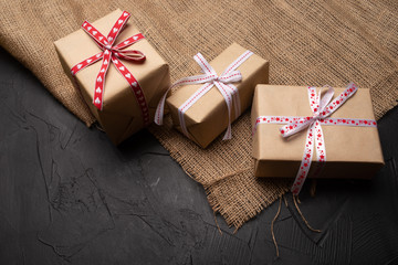gift box with red ribbon and bow on wooden background