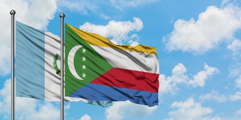 Guatemala and Comoros flag waving in the wind against white cloudy blue sky together. Diplomacy...