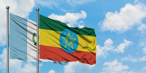 Guatemala and Ethiopia flag waving in the wind against white cloudy blue sky together. Diplomacy concept, international relations.