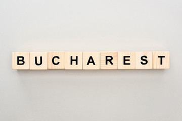 top view of wooden blocks with Bucharest lettering on grey background