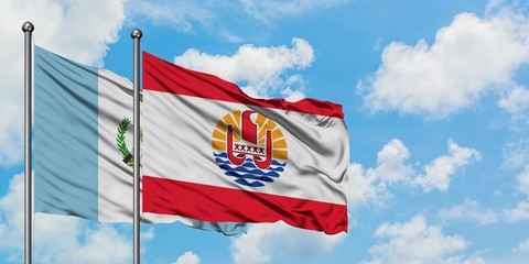 Guatemala and French Polynesia flag waving in the wind against white cloudy blue sky together. Diplomacy concept, international relations.