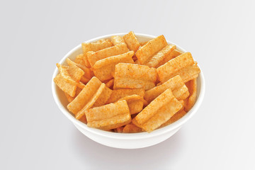 Fried and Spicy Chokadi, cross Snacks or Fryums (Snacks Pellets) is a very popular Gujarati snack, white bowl on white background, pouch packing common street snack from India. selective focus - Image