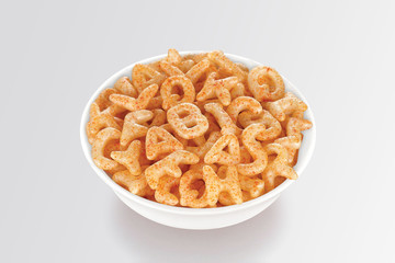 Fried and Spicy Alphabet, ABCD, A-B-C-D, Snacks or Fryums (Snacks Pellets) served in a white bowl....
