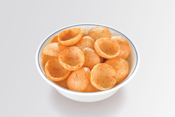 Fried and Spicy Moon Cup, Vatka, Katori, Moon Chips, Snacks or Fryums (Snacks Pellets) served in a bowl or White background. selective focus - Image - Image
