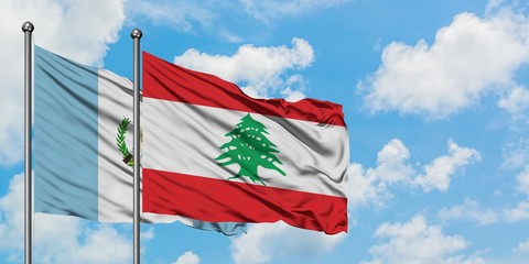 Guatemala and Lebanon flag waving in the wind against white cloudy blue sky together. Diplomacy concept, international relations.