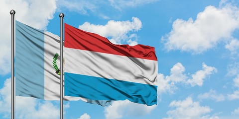 Guatemala and Luxembourg flag waving in the wind against white cloudy blue sky together. Diplomacy concept, international relations.