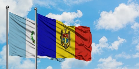 Guatemala and Moldova flag waving in the wind against white cloudy blue sky together. Diplomacy concept, international relations.