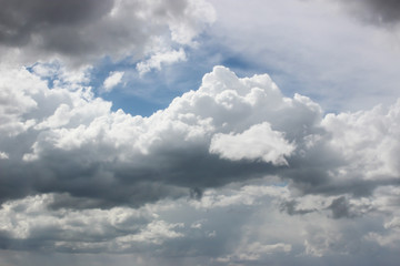 White and dark grey clouds on the blue sky