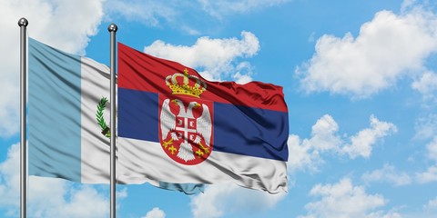 Guatemala and Serbia flag waving in the wind against white cloudy blue sky together. Diplomacy concept, international relations.