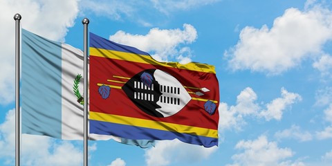 Guatemala and Swaziland flag waving in the wind against white cloudy blue sky together. Diplomacy concept, international relations.