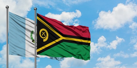 Guatemala and Vanuatu flag waving in the wind against white cloudy blue sky together. Diplomacy...