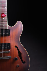 Obraz na płótnie Canvas Hollow electric guitar with f-holes. Isolated on black.