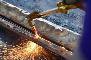 Worker cutting metal plate by Gas Cutting Torch in the workshop.
