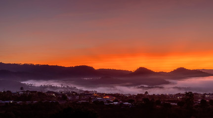 View of village covered in foggy during morning sunrise.
