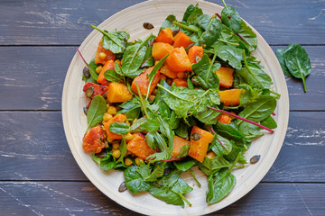 Healthy salad with spinach and sauted pumkin