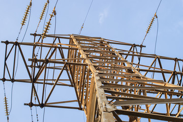metal carcass of power electric transmission lines with wires insulators and wires at electrical substation with transformers