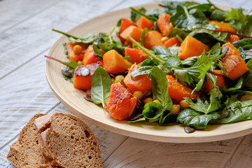 Healthy salad with spinach and sauted pumkin