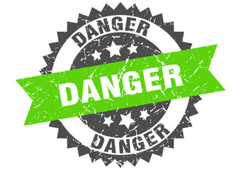 danger grunge stamp with green band. danger