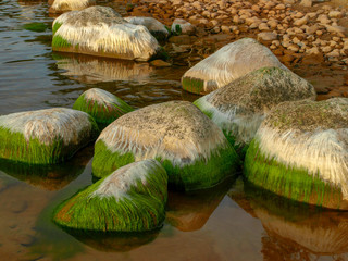 landscape with beautiful rocks by the sea, colorful reflections in the water