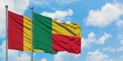 Guinea and Benin flag waving in the wind against white cloudy blue sky together. Diplomacy concept, international relations.