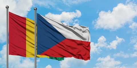 Guinea and Czech Republic flag waving in the wind against white cloudy blue sky together. Diplomacy concept, international relations.