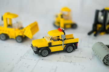 Car toys  transport construction on architectural project, construction plan concept