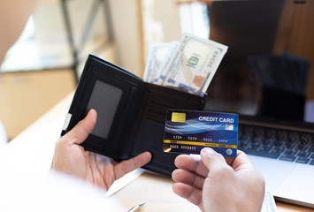 Online shopping concept, young men use credit cards to pay for products online via the internet