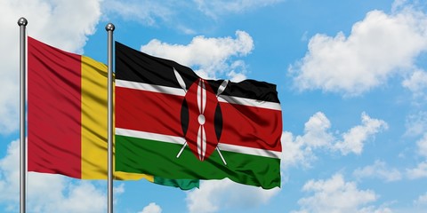 Guinea and Kenya flag waving in the wind against white cloudy blue sky together. Diplomacy concept, international relations.